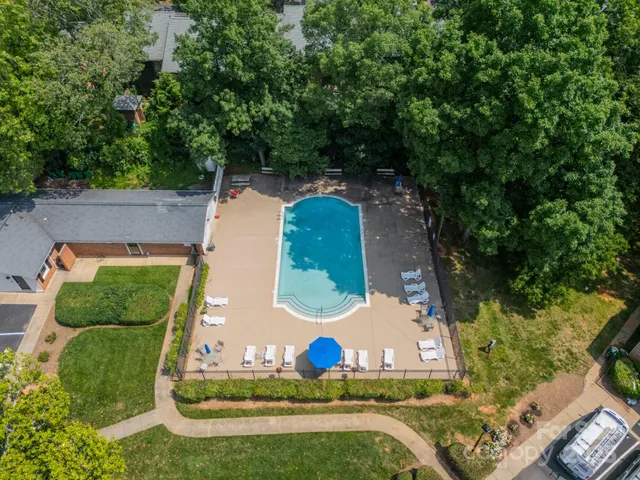 an aerial view of a house with outdoor space pool seating area and yard