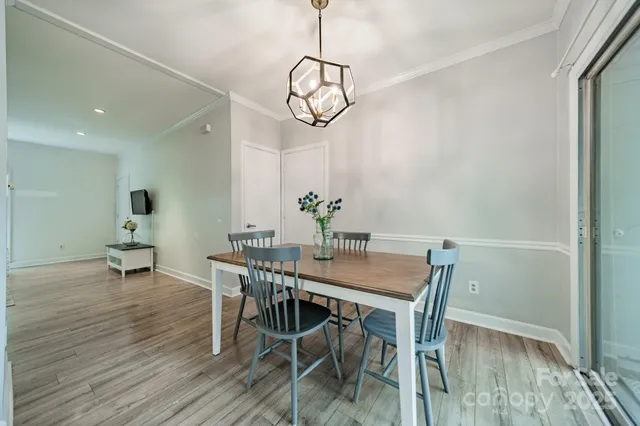 a view of a dining room with furniture wooden floor and a chandelier