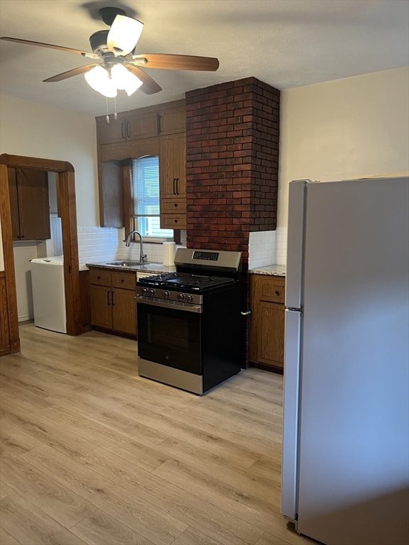 10 Antrim Street, Unit 2 Boston, MA 02128 - Photo 13 of 18 a kitchen with stainless steel appliances granite countertop a stove a sink and a refrigerator