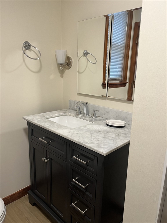 10 Antrim Street, Unit 2 Boston, MA 02128 - Photo 15 of 18 a bathroom with a granite countertop sink and a mirror