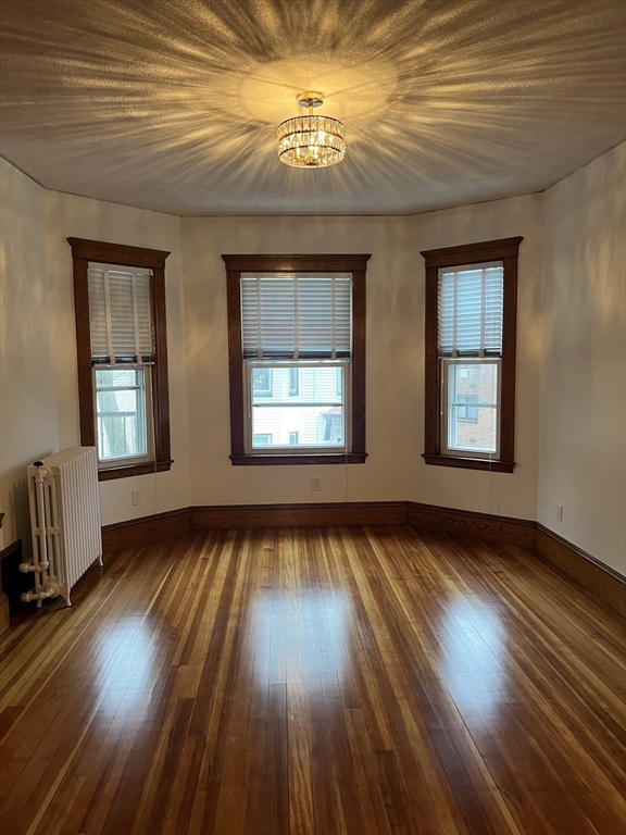 10 Antrim Street, Unit 2 Boston, MA 02128 - Photo 5 of 18 a view of an empty room with wooden floor and a window
