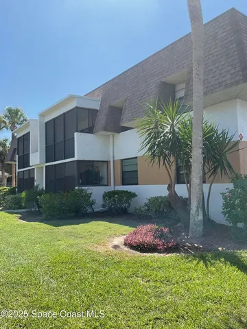 a view of a house with a yard and a patio