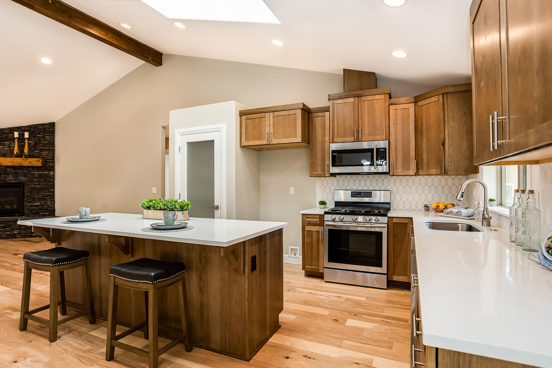 60031 Agate Road Bend, OR 97702 - Photo 6 of 14 a kitchen with stainless steel appliances granite countertop a stove top oven a sink dishwasher a dining table and chairs with wooden floor