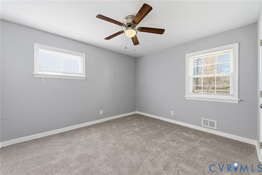 510 Jade Road North Chesterfield, VA 23236 - Photo 14 of 27 an empty room with ceiling fan and windows