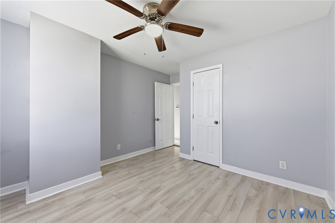 510 Jade Road North Chesterfield, VA 23236 - Photo 19 of 27 an empty room with wooden floor ceiling fan and windows