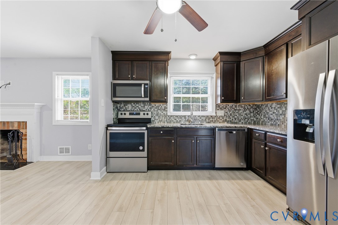 510 Jade Road North Chesterfield, VA 23236 - Photo 9 of 27 a kitchen with granite countertop a stove and a refrigerator