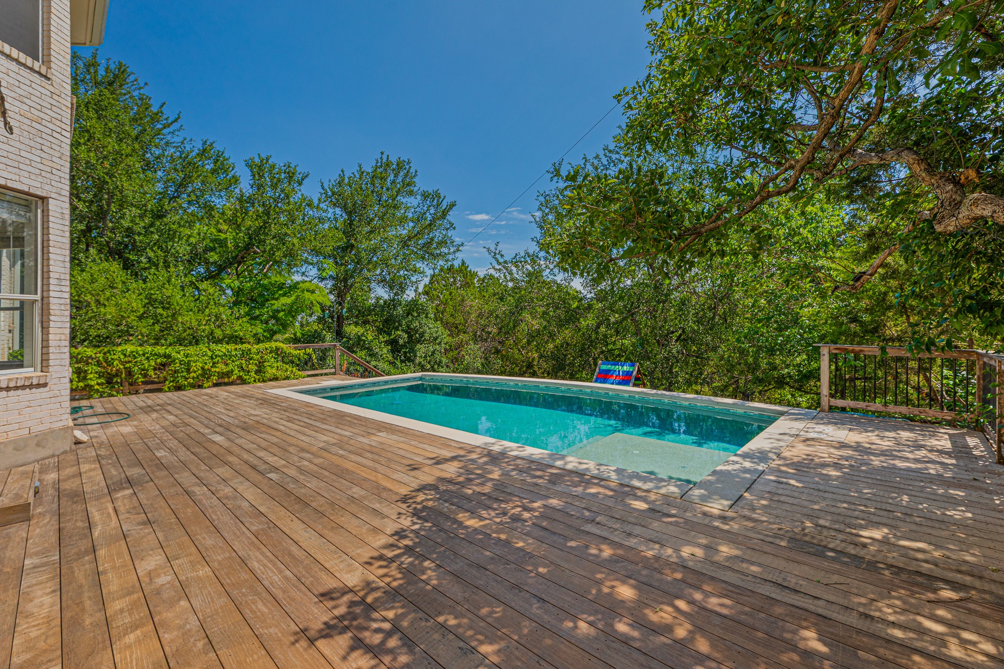 304 River Down Road Georgetown, TX 78628 - Photo 19 of 22 Expansive outdoor deck featuring an in-ground swimming pool with integrated steps