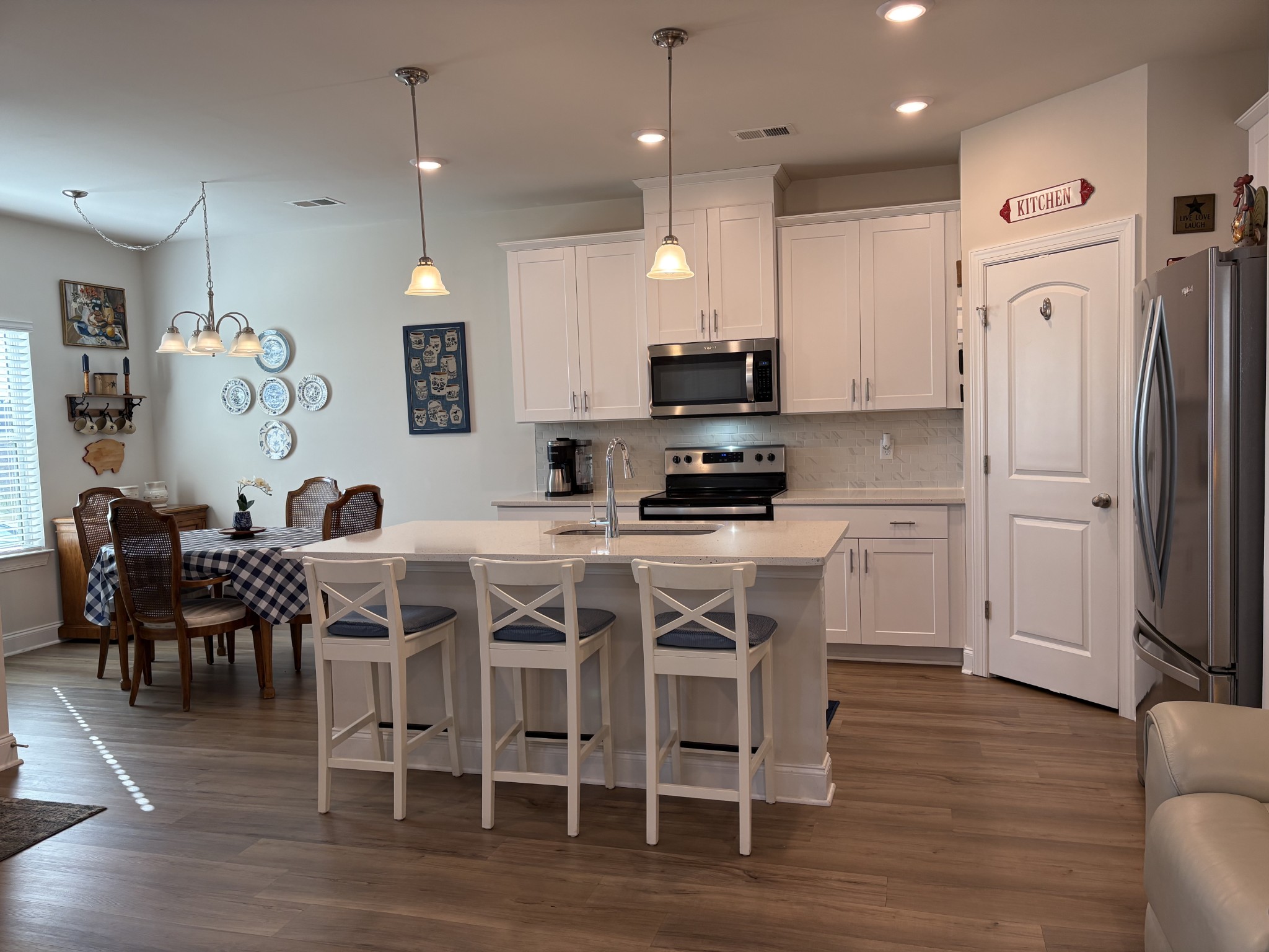 672 Taylor Bend Columbia, TN 38401 - Photo 7 of 32 a kitchen with stainless steel appliances kitchen island granite countertop a dining table chairs and sink