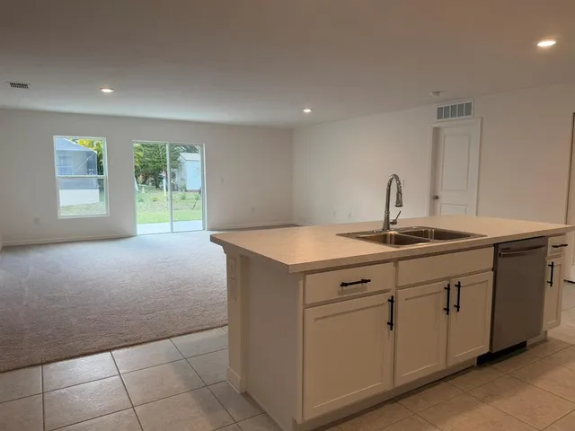 a view of a livingroom with an empty space and a window