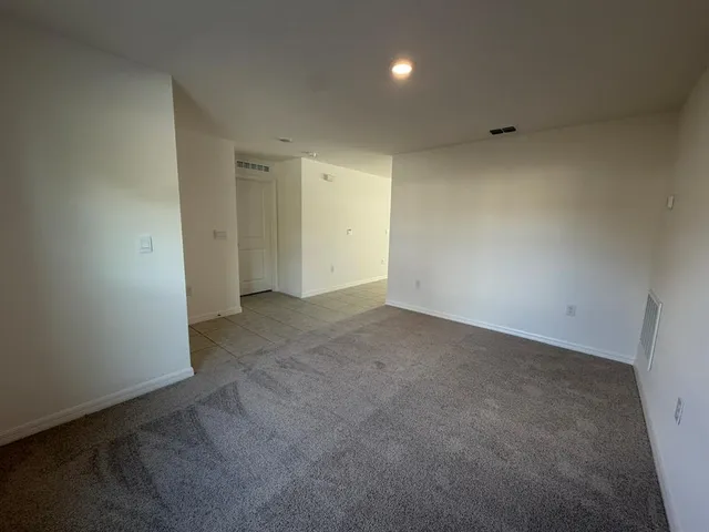 a bathroom with a granite countertop sink a toilet and shower