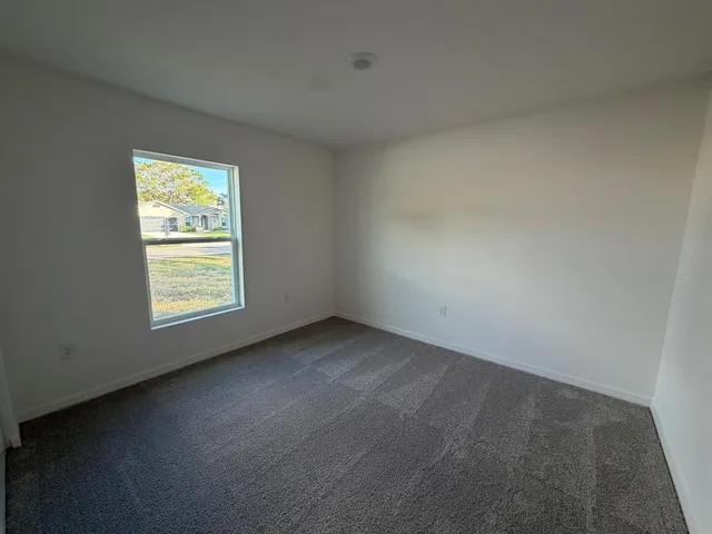 a bathroom with a granite countertop sink a toilet and a mirror