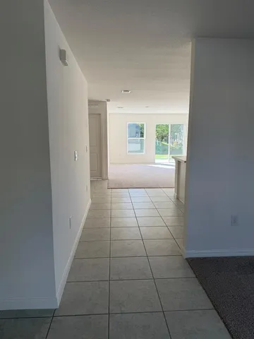 a view of kitchen with stainless steel appliances granite countertop a white stove top oven and white cabinets