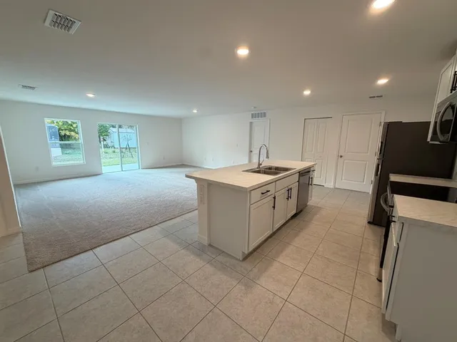 a kitchen with a refrigerator stove and microwave
