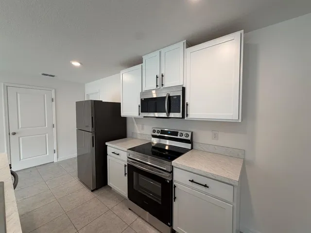 a kitchen with a sink stainless steel appliances and cabinets