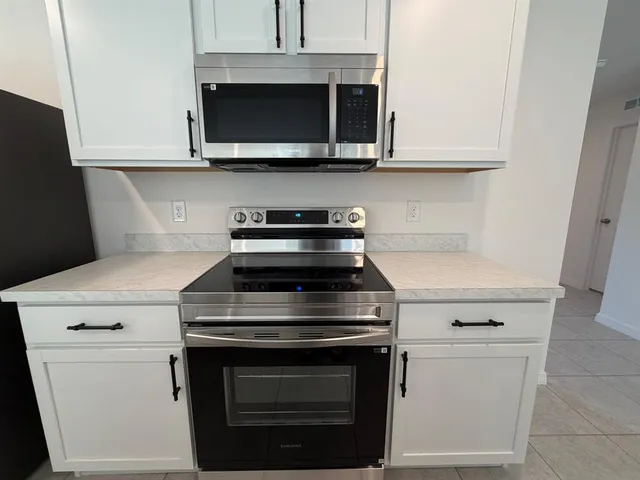 a kitchen with a sink a microwave and refrigerator