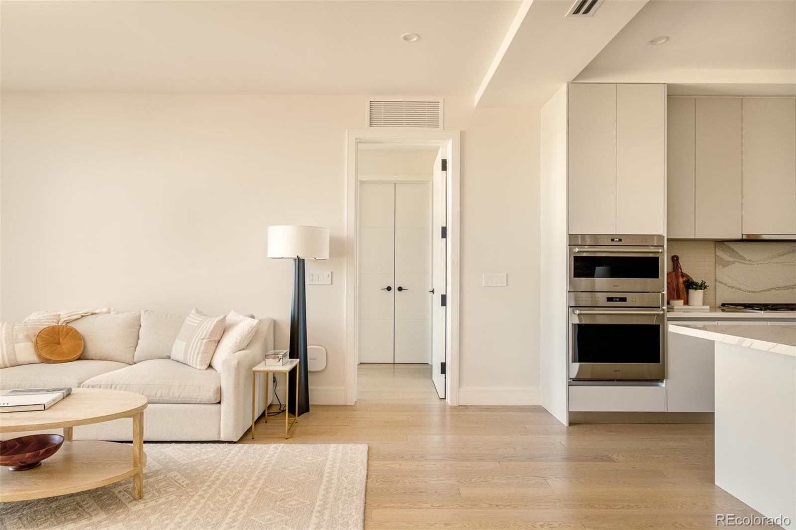 1901 Wazee Street, Unit 704 Denver, CO 80202 - Photo 12 of 49 a living room with furniture and a wooden floor