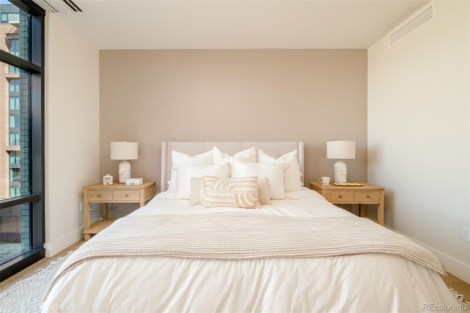 1901 Wazee Street, Unit 704 Denver, CO 80202 - Photo 16 of 49 a bedroom with a bed and a night stand