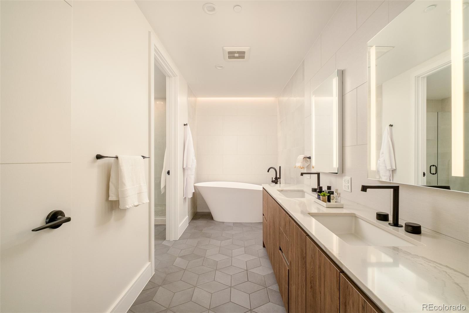 1901 Wazee Street, Unit 704 Denver, CO 80202 - Photo 17 of 49 a bathroom with a tub sink and mirror