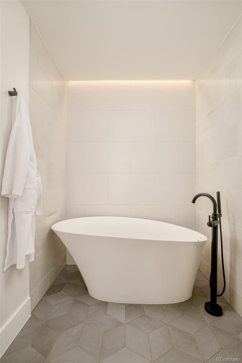 1901 Wazee Street, Unit 704 Denver, CO 80202 - Photo 19 of 49 a white bath tub sitting in a bathroom