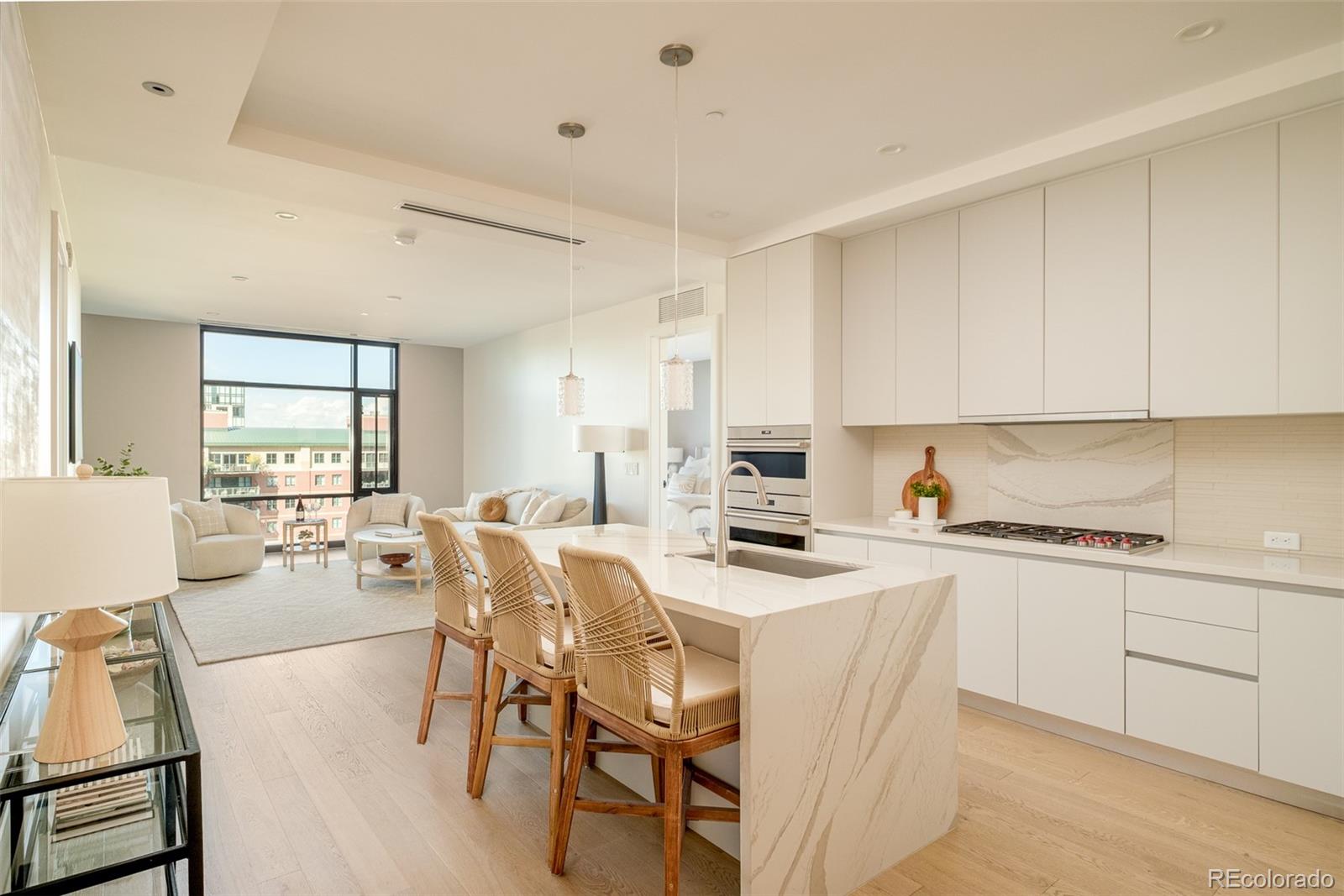 1901 Wazee Street, Unit 704 Denver, CO 80202 - Photo 6 of 49 a kitchen with appliances a stove a table and chairs in it