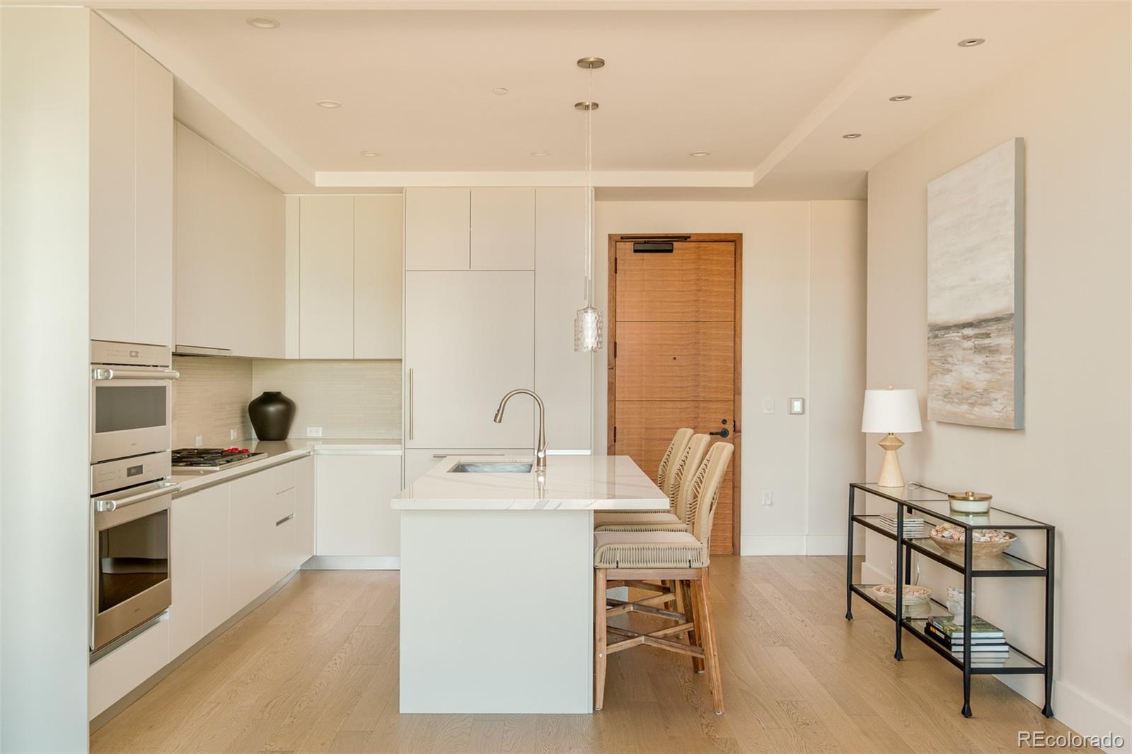 1901 Wazee Street, Unit 704 Denver, CO 80202 - Photo 7 of 49 a large white kitchen with sink and cabinets