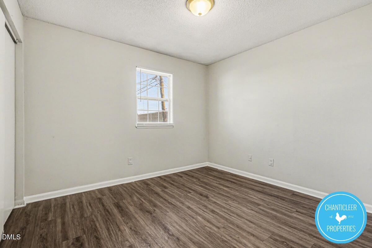 115 Florence Street, Unit 14 Graham, NC 27253 - Photo 15 of 29 an empty room with wooden floor and windows