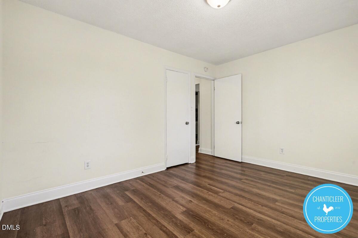 115 Florence Street, Unit 14 Graham, NC 27253 - Photo 17 of 29 a view of an empty room with wooden floor