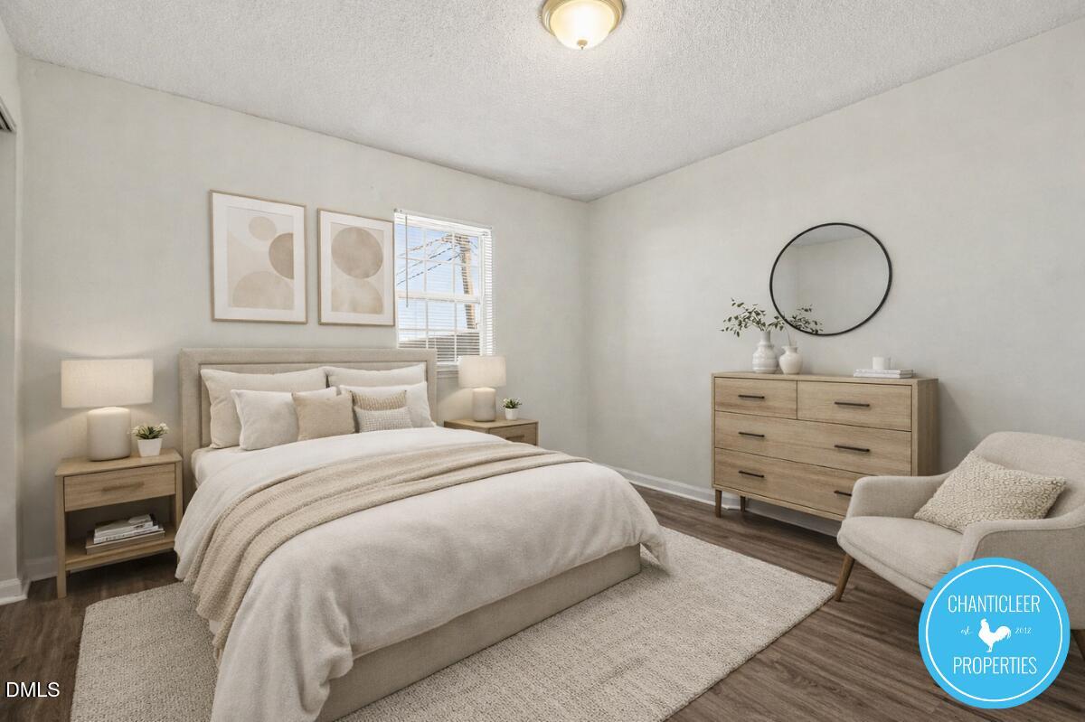115 Florence Street, Unit 14 Graham, NC 27253 - Photo 19 of 29 a bedroom with a bed and a chair
