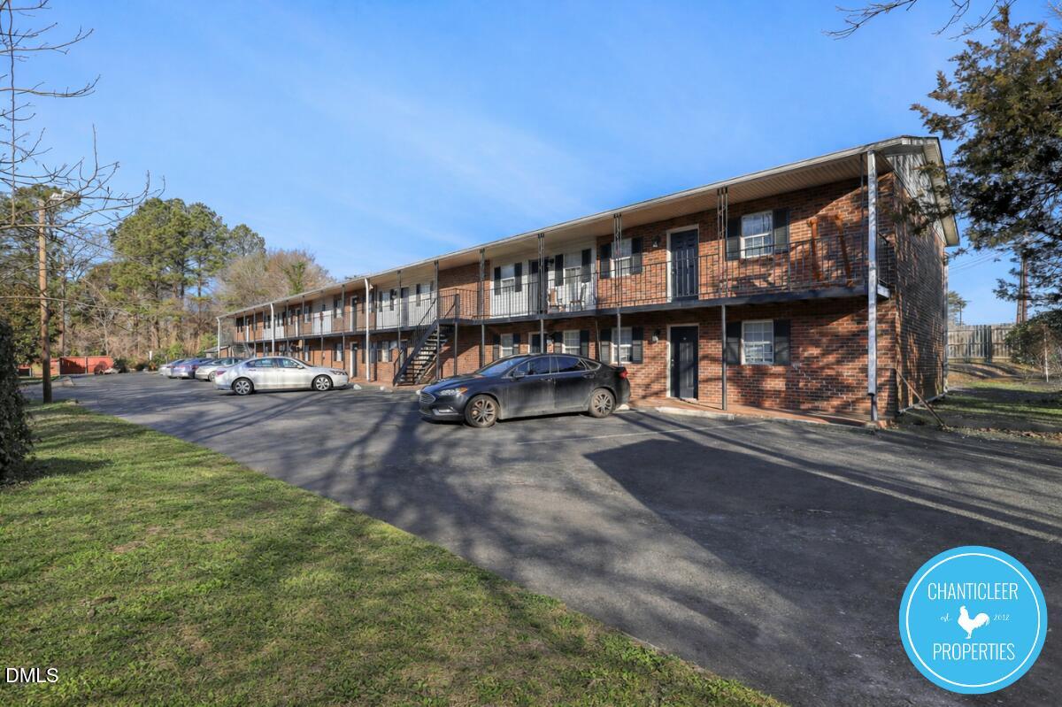 115 Florence Street, Unit 14 Graham, NC 27253 - Photo 2 of 29 a view of building with large trees and playing area