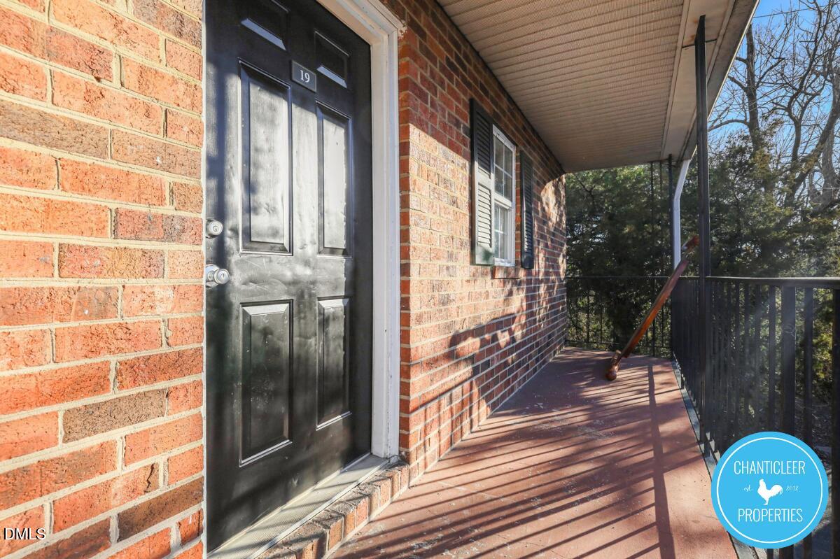 115 Florence Street, Unit 14 Graham, NC 27253 - Photo 27 of 29 a view of a balcony with wooden floor and iron stairs