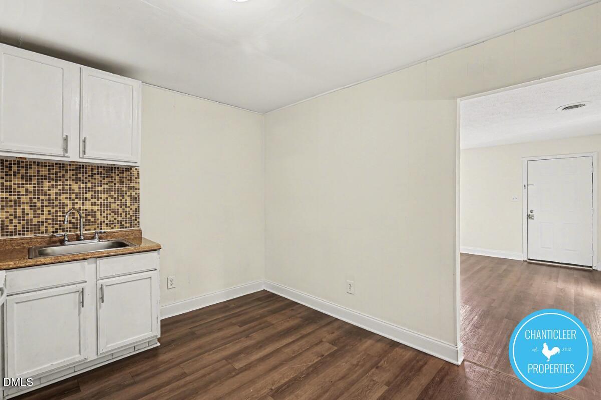 115 Florence Street, Unit 14 Graham, NC 27253 - Photo 5 of 29 a view of a storage and utility room with wooden floor