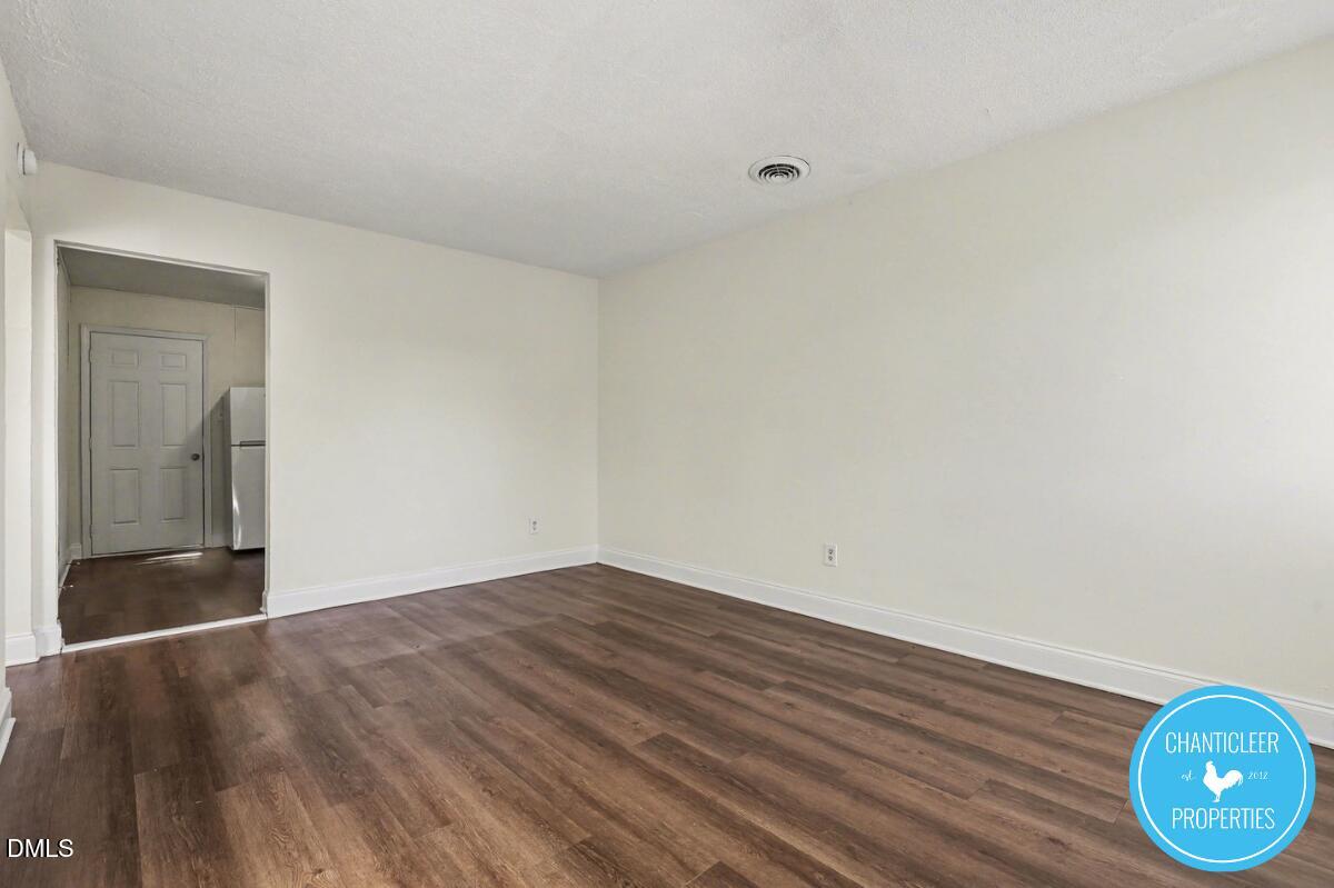 115 Florence Street, Unit 14 Graham, NC 27253 - Photo 6 of 29 a view of an empty room with closet and wooden floor