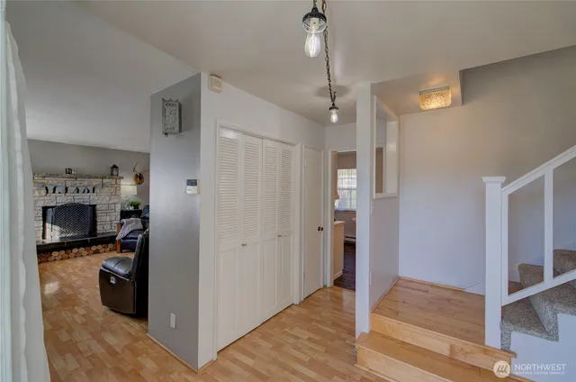 a view of a hallway with wooden floor and workspace