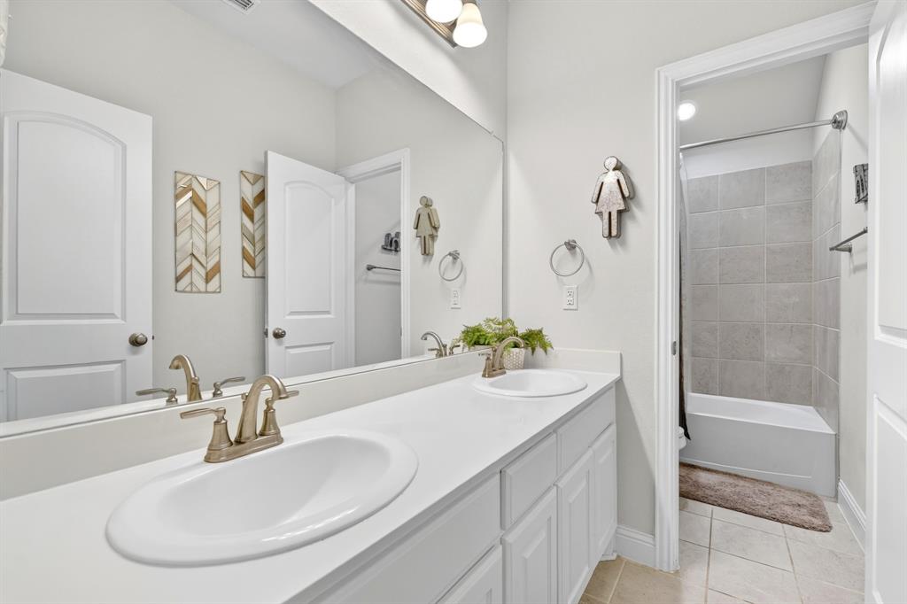 136 Gleeson Drive Red Oak, TX 75154 - Photo 25 of 40 a bathroom with a granite countertop sink and a mirror