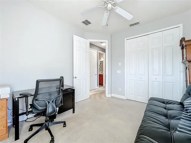 a view of a livingroom with workspace and a window