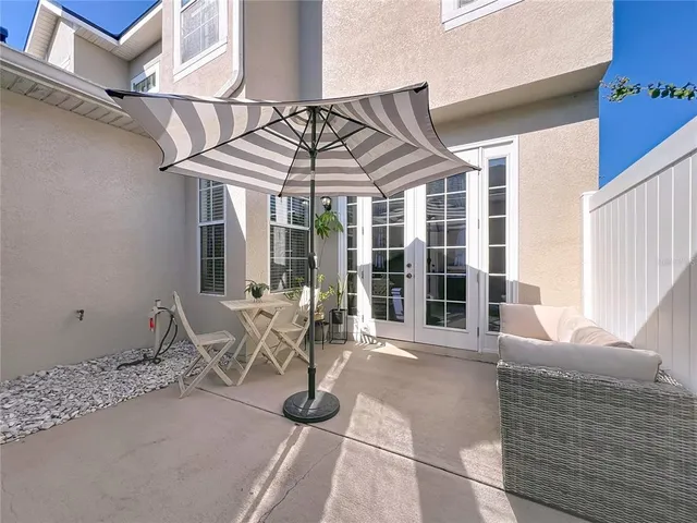 a view of a house with backyard porch and sitting area