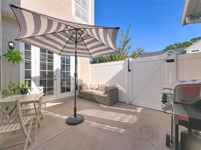a patio with a table and chairs