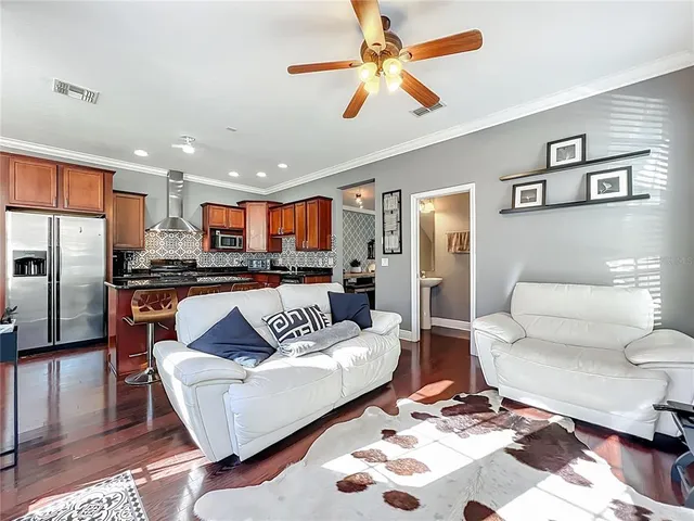a living room with furniture and kitchen view