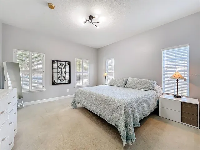 a spacious bedroom with a bed and a window