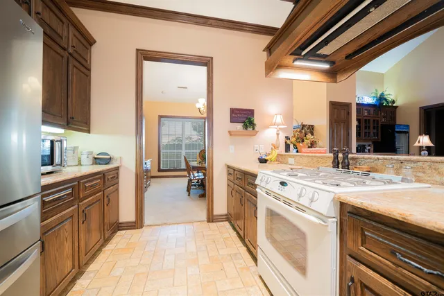 a kitchen with stainless steel appliances granite countertop a stove and a sink