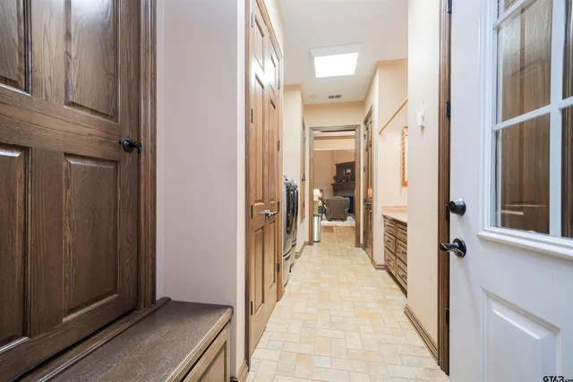 a view of a hallway with a wooden cabinets