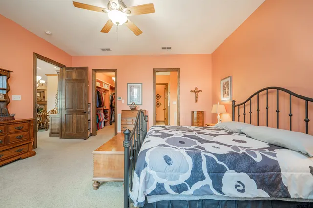 a bedroom with a bed next to a window with the outer view