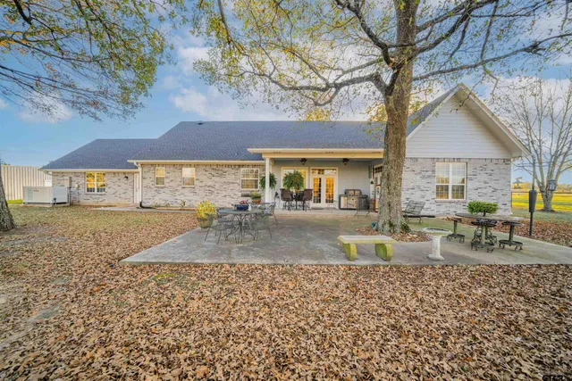 a view of a house with a yard and sitting area