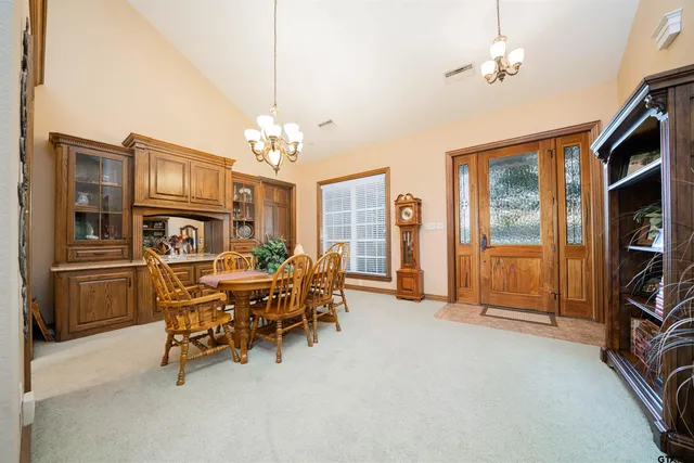 a view of a livingroom with furniture and chandelier