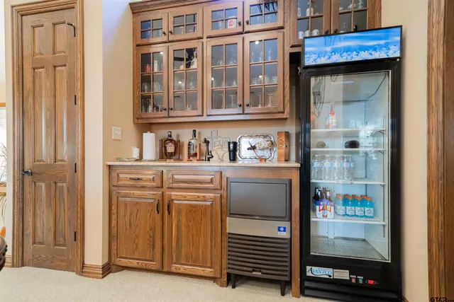 a kitchen with a refrigerator and cabinets
