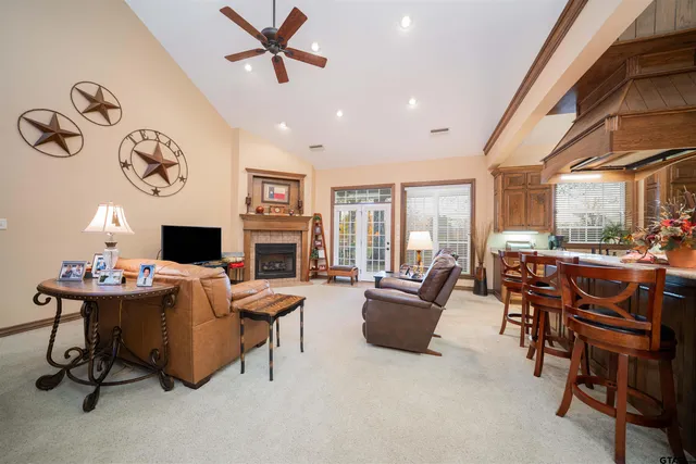 a living room with fireplace furniture and a large window