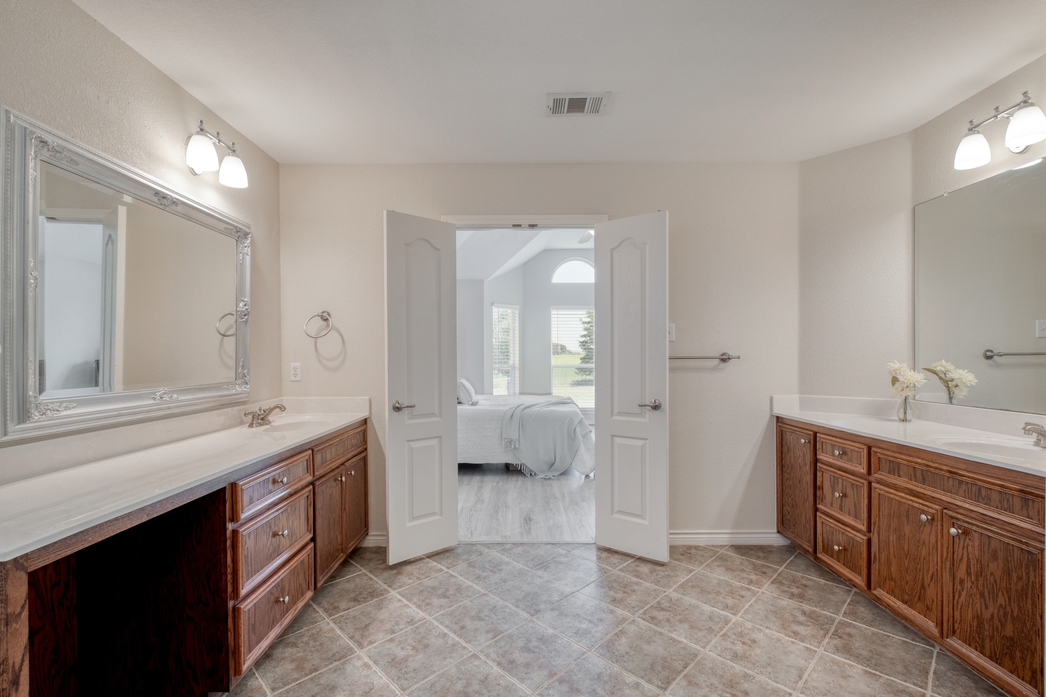 341 Brown Road McDade, TX 78650 - Photo 22 of 38 Double vanities and private entry to the primary bedroom elevate this bathroom's appeal.