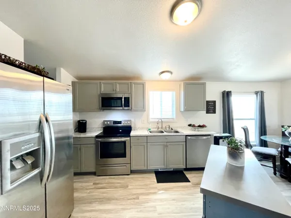 a living room with furniture window and a flat screen tv