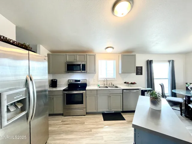 a living room with furniture window and a flat screen tv