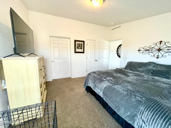 a bedroom with a bed and a television